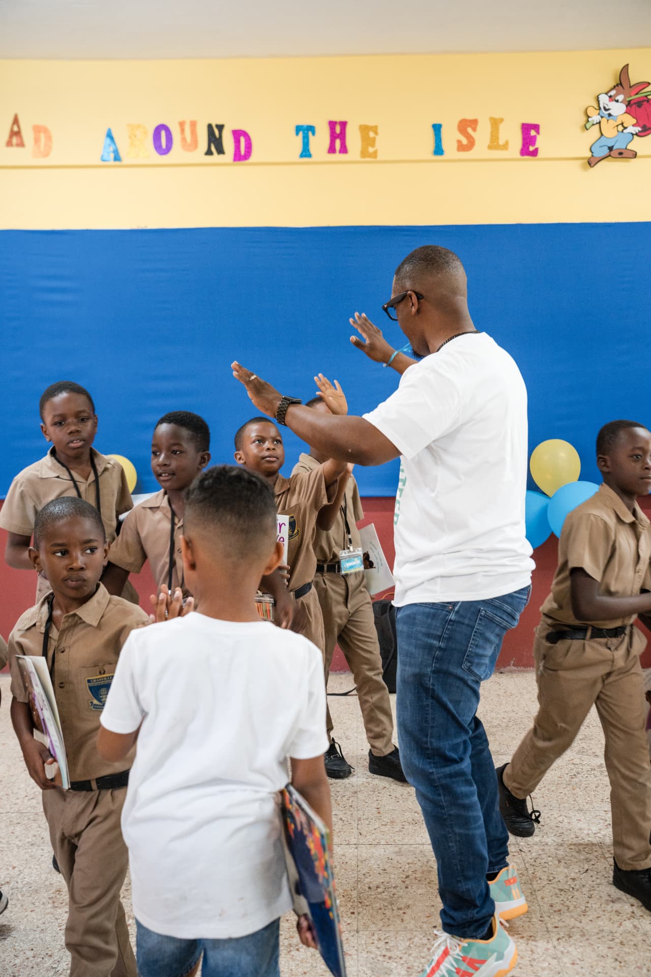 Primary-grade students holding books during a Read Around the Isle session